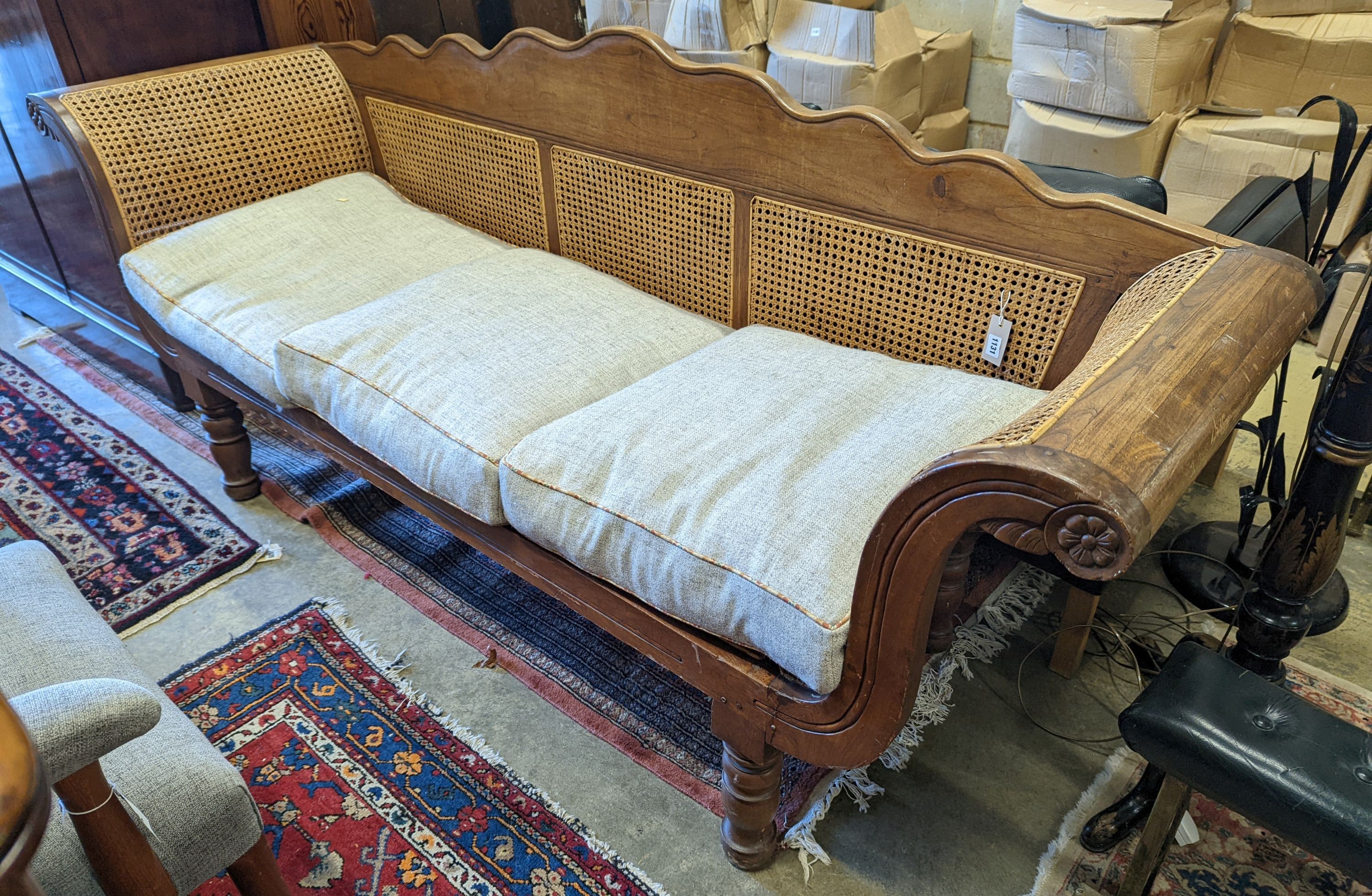 A Colonial caned teak settee with loose cushion seat, length 214cm, depth 62cm, height 95cm